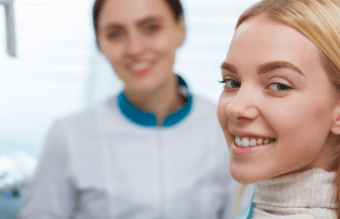 Smiling young woman looking at the camera in dental office