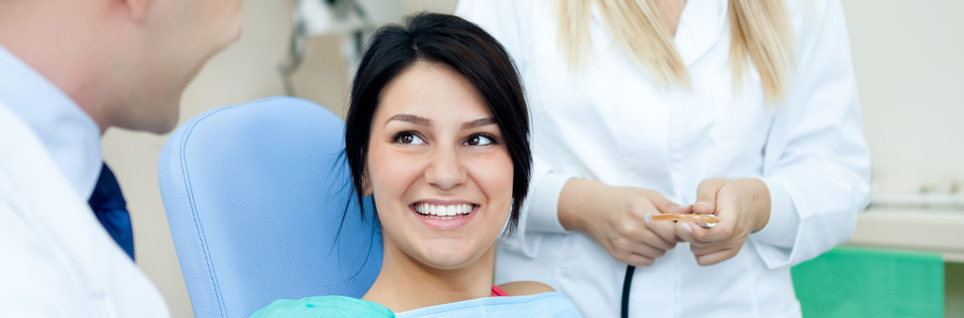 young beautiful woman smiling looking at dentist